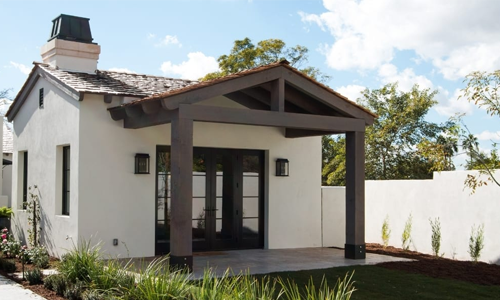 Beautiful small house with a wood-beamed portico over front entrance