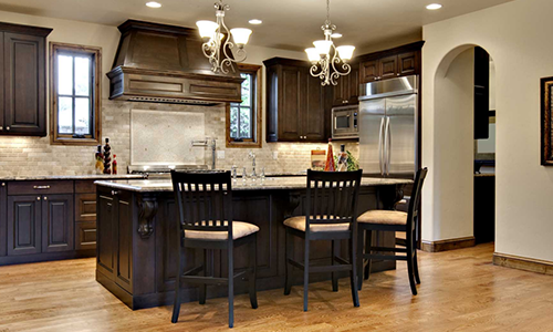 Beautiful kitchen remodel with dark finishes and granite counters