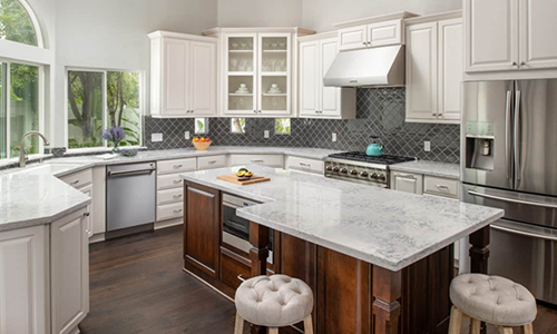 Remodeled kitchen with granite island, custom cabinets, and wood floors