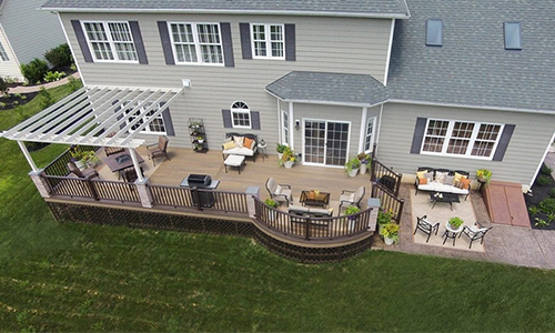 Aerial view of a beautiful home with vinyl siding and a large porch