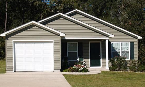 Cozy home with vinyl siding and a well-maintained lawn