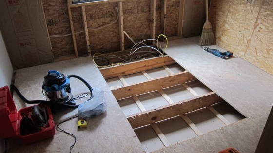 Subfloor replacement process in progress.