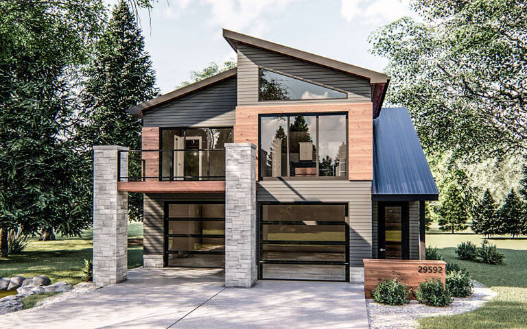 Modern tiny home with a balcony on stone pillars and wood and grey siding.